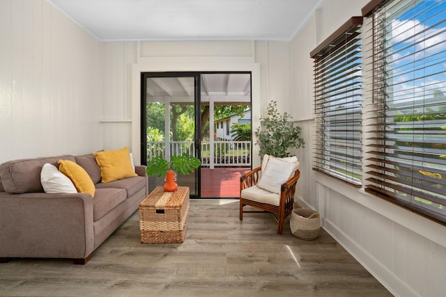 3821-B Ohuohu Rd, Koloa, HI 96756 - living room with wood finished floors, plenty of natural light, crown molding, and a decorative wall