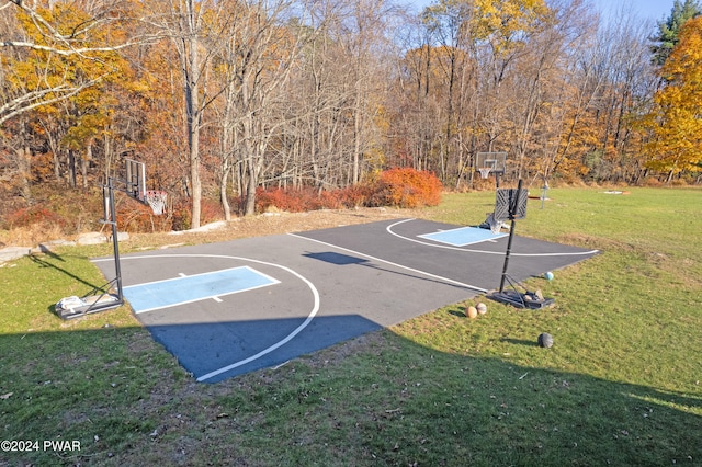 view of basketball court with a lawn