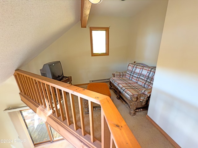 interior space featuring a textured ceiling, lofted ceiling with beams, carpet floors, and a baseboard radiator