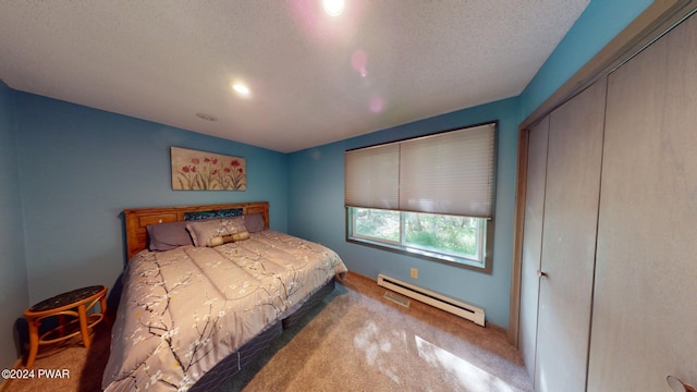 bedroom with a textured ceiling, carpet floors, and baseboard heating