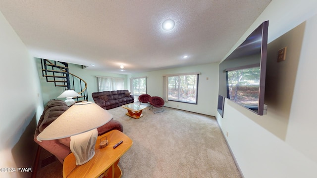 living room with light carpet and a textured ceiling