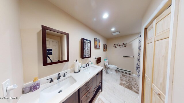 bathroom with tile patterned flooring, vanity, toilet, and baseboard heating