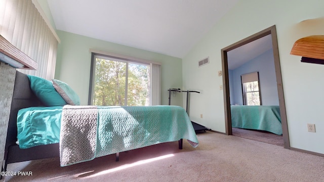 carpeted bedroom featuring vaulted ceiling