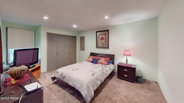 carpeted bedroom with a closet