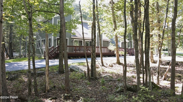 back of house with a wooden deck