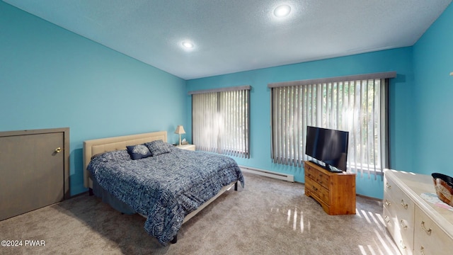 carpeted bedroom featuring a textured ceiling and baseboard heating