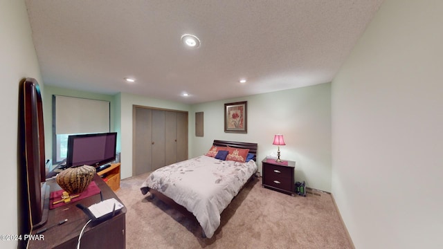 carpeted bedroom featuring a closet and a textured ceiling