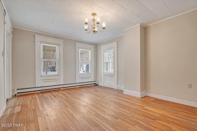 unfurnished dining area featuring crown molding, baseboards, light wood-type flooring, baseboard heating, and an inviting chandelier