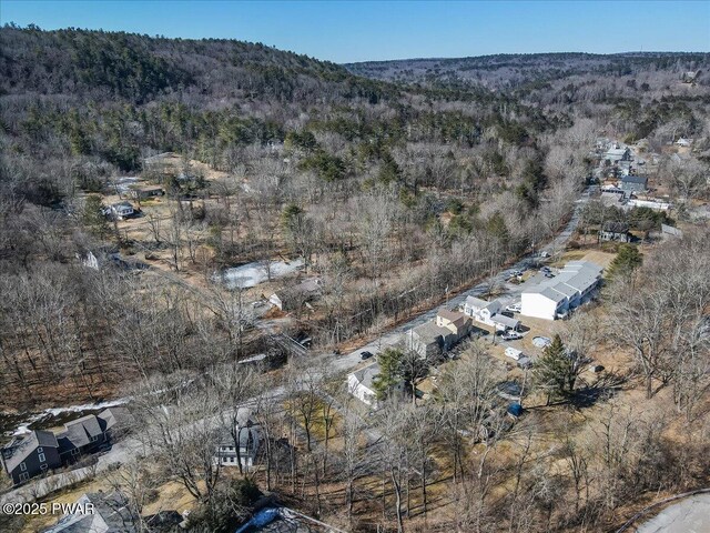 birds eye view of property with a wooded view