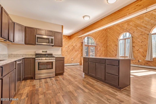 kitchen featuring light wood finished floors, baseboard heating, and stainless steel appliances