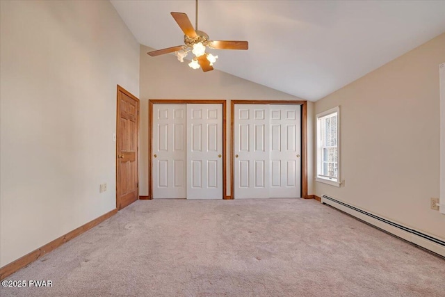 unfurnished bedroom with carpet flooring, baseboards, a baseboard heating unit, and multiple closets