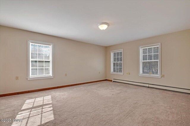 unfurnished room featuring baseboards, baseboard heating, and carpet flooring