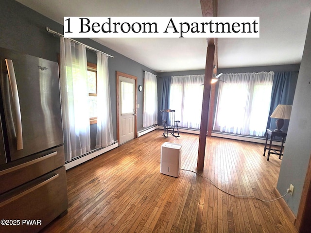 27 Maple Trail, Trail, NY 12790 - unfurnished living room with a baseboard heating unit and hardwood / wood-style flooring