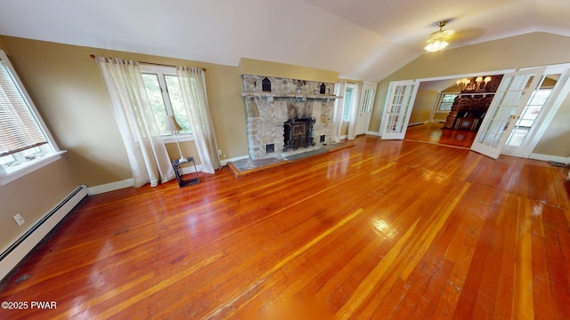27 Maple Trail, Trail, NY 12790 - unfurnished living room with a baseboard heating unit, a fireplace, hardwood / wood-style floors, a ceiling fan, and lofted ceiling