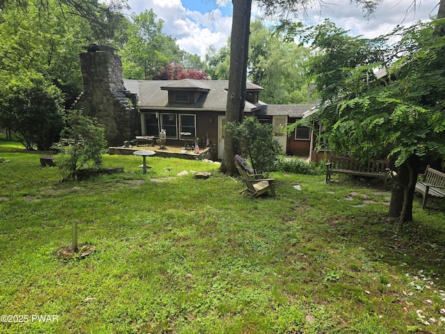 27 Maple Trail, Trail, NY 12790 - back of property with a yard, a chimney, and a patio