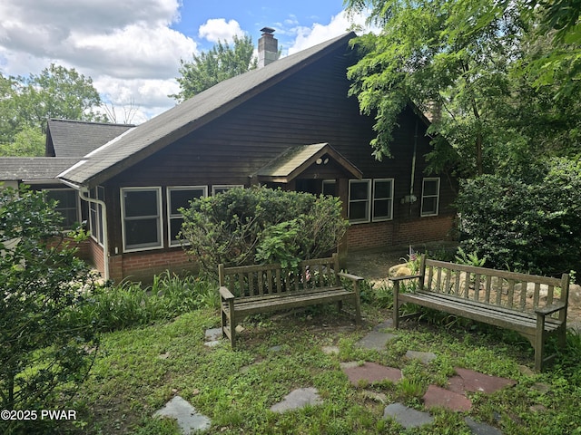 27 Maple Trail, Trail, NY 12790 - rear view of property featuring brick siding, a chimney, and roof with shingles