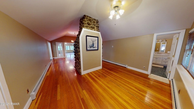 27 Maple Trail, Trail, NY 12790 - corridor featuring a baseboard radiator, a baseboard heating unit, lofted ceiling, light wood finished floors, and a chandelier