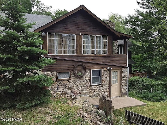 27 Maple Trail, Trail, NY 12790 - view of front of house with stone siding and a chimney
