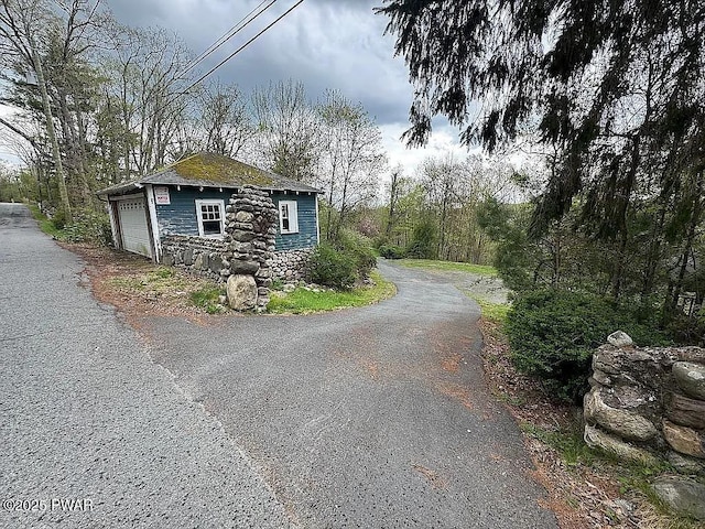 27 Maple Trail, Trail, NY 12790 - view of side of home with stone siding, a garage, and an outdoor structure