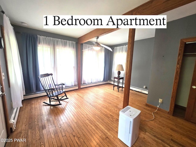 27 Maple Trail, Trail, NY 12790 - sitting room with hardwood / wood-style floors, a baseboard heating unit, a ceiling fan, and beamed ceiling