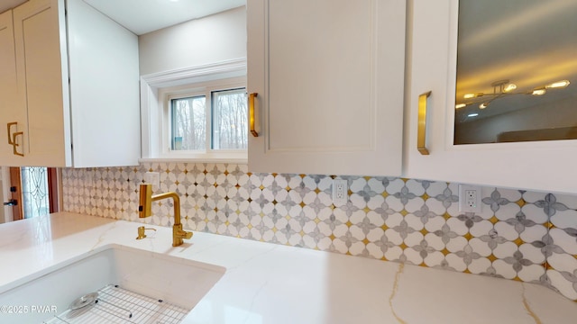 bathroom with a sink and backsplash