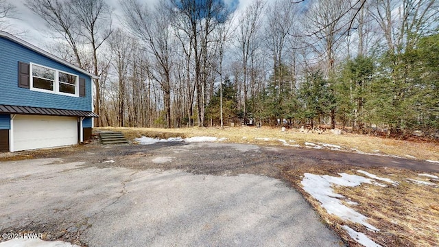 view of yard with driveway and an attached garage