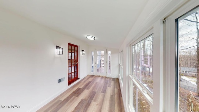 unfurnished sunroom featuring visible vents