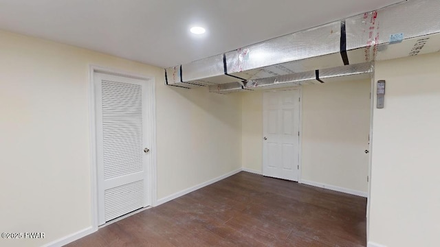 basement featuring baseboards, wood finished floors, and recessed lighting