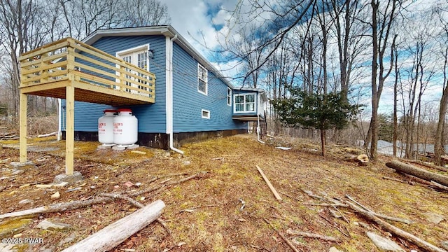 view of home's exterior with a wooden deck