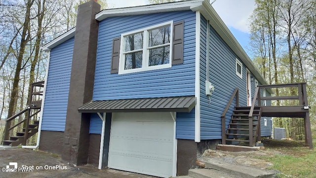 1 Mountain Crest Dr, Lake Ariel, PA 18436 - exterior space featuring a chimney, stairway, central AC unit, and an attached garage