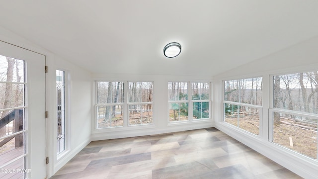 unfurnished sunroom with lofted ceiling