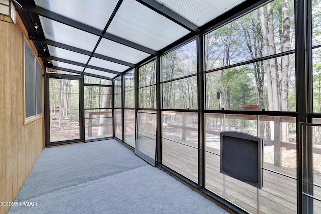 unfurnished sunroom featuring plenty of natural light and lofted ceiling