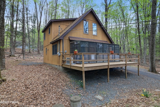 rear view of property with a wooden deck