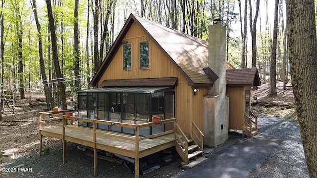 view of outbuilding with a sunroom