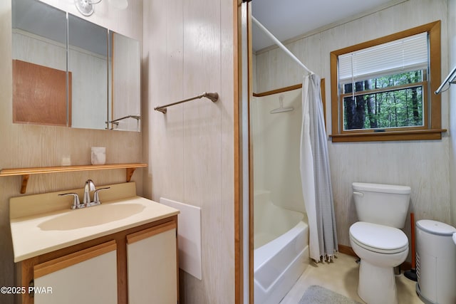 bathroom featuring toilet, vanity, and shower / tub combo