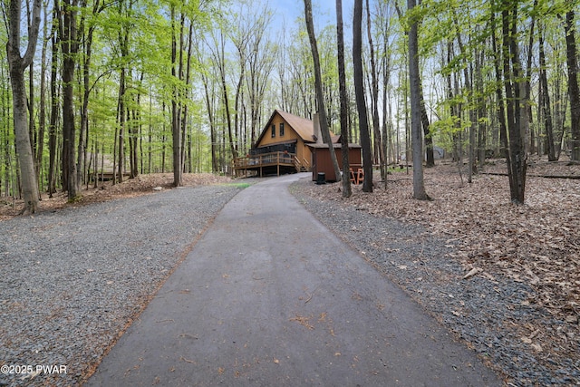 surrounding community with asphalt driveway