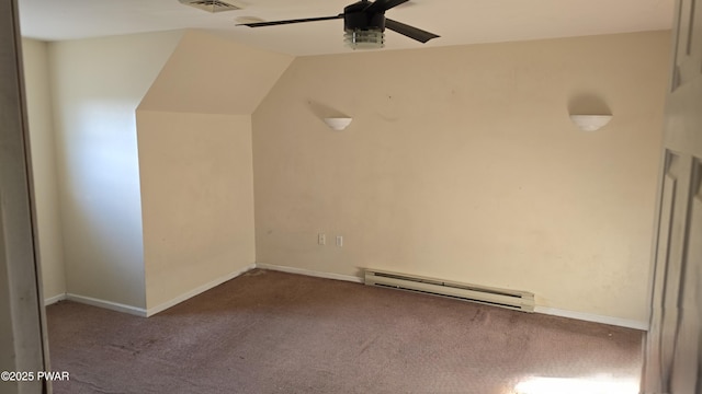 additional living space featuring visible vents, carpet, vaulted ceiling, baseboard heating, and a ceiling fan