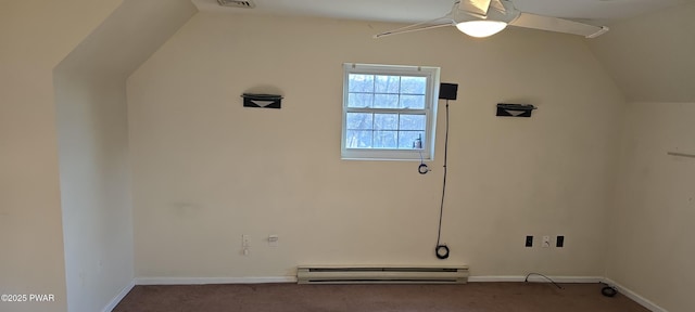 interior space with baseboard heating, carpet floors, ceiling fan, and vaulted ceiling