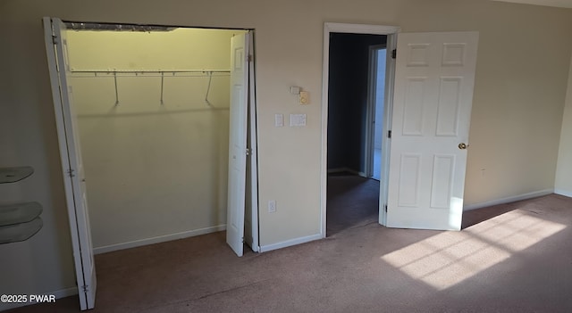 unfurnished bedroom featuring baseboards, a closet, and carpet floors