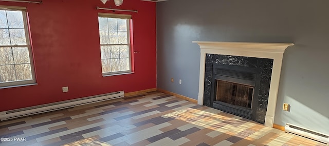 unfurnished living room featuring a baseboard heating unit, baseboards, and a premium fireplace