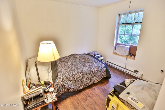 174 Laverne Dr, Dingmans Ferry, PA 18328 - bedroom featuring baseboard heating and wood finished floors
