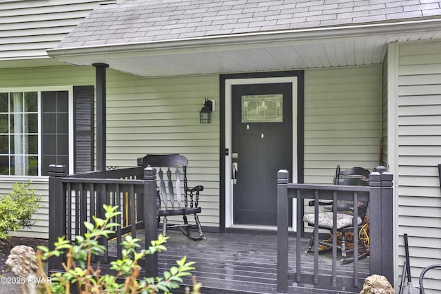 174 Laverne Dr, Dingmans Ferry, PA 18328 - view of exterior entry featuring roof with shingles and a deck