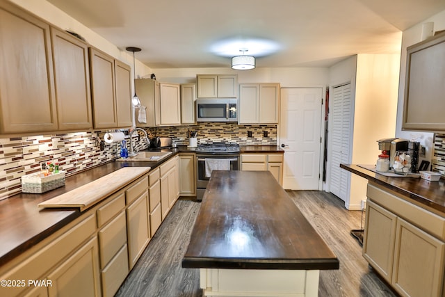 174 Laverne Dr, Dingmans Ferry, PA 18328 - kitchen featuring stainless steel appliances, butcher block counters, tasteful backsplash, dark wood-style floors, and a kitchen island