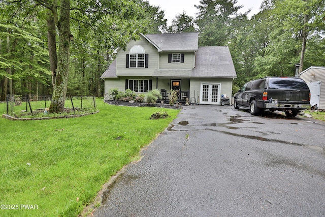 174 Laverne Dr, Dingmans Ferry, PA 18328 - traditional home with french doors, a front lawn, asphalt driveway, and covered porch