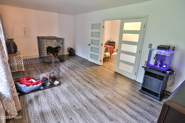174 Laverne Dr, Dingmans Ferry, PA 18328 - living room with electric panel, wood finished floors, and a wood stove