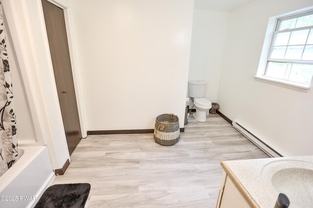 174 Laverne Dr, Dingmans Ferry, PA 18328 - full bath with baseboard heating, vanity, wood finished floors, and shower / tub combo