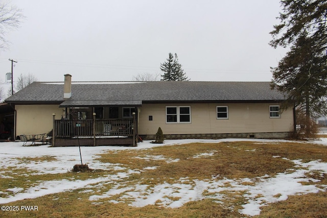 snow covered property with a porch