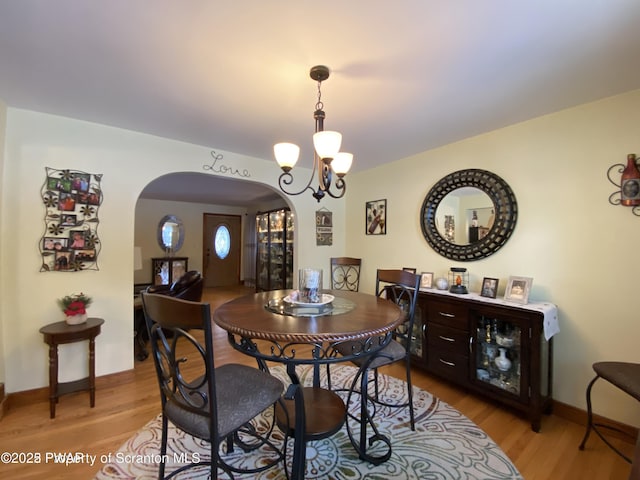 dining room featuring a chandelier and light hardwood / wood-style flooring