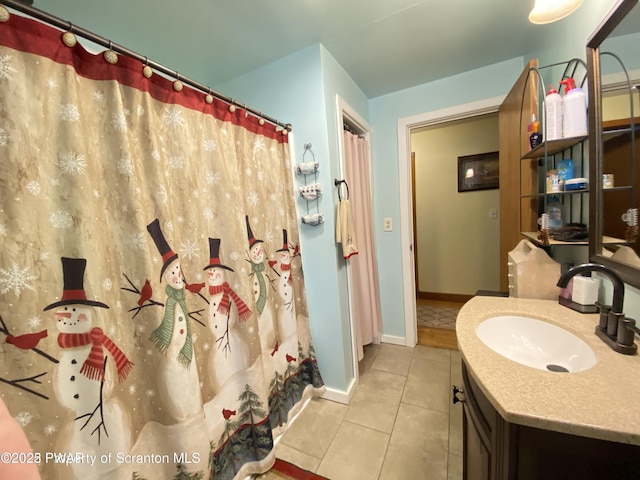 bathroom featuring tile patterned flooring, vanity, and curtained shower