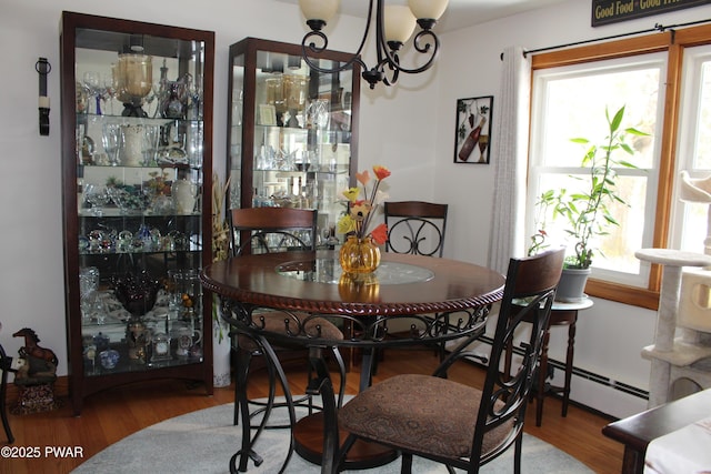 dining area with an inviting chandelier and hardwood / wood-style floors